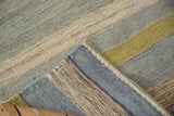 Handwoven texture and secure side selvage of a striped vintage Turkish Kilim.
