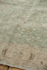 Distressed vintage Sparta carpet pile showing subtle floral patterns in mint green and ivory.