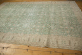 Distressed vintage Sparta carpet texture, with faded dusty mint green floral field and ivory border.
