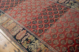 Staggered floral motifs creating movement across the evenly worn pile of a distressed Oushak runner.