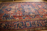 Vintage Karaja rug detail: red and navy samovar border, geometric field, mostly even wear.