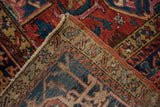 Folded vintage Karaja rug detail, showing its geometric brick red pile and natural woven backing.