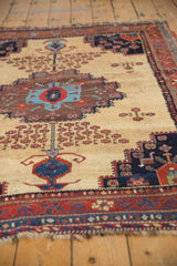 Detailed stepped medallion, cherry red, sky blue geometric florals on an ivory Afshar rug.