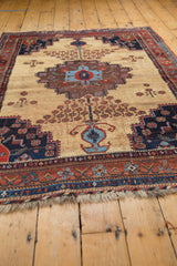 Antique Afshar rug border displaying intricate madder root red, sky blue details, and tattered fringe.
