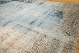 Distressed Turkish Sparta carpet, faded denim blue field, visible foundation, worn borders.