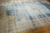 Distressed texture of the vintage Sparta carpet, with faded denim blue and antique ivory.