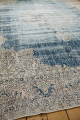 Distressed texture of vintage Sparta carpet, with worn denim blue and ivory floral design.