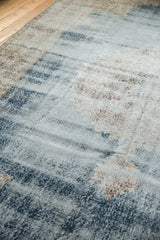 Distressed Turkish Sparta carpet showing worn texture, faded denim blue and apricot patterns.