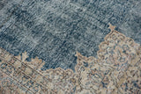 Patina of a vintage distressed Sparta carpet, showing denim blue field, visible knot heads, and beige patterns.