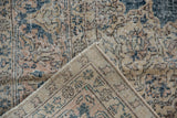 Worn denim blue and beige pile of distressed Sparta rug, revealing hand knotted foundation.