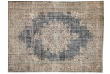 Distressed vintage Sparta carpet with faded navy field, ivory medallion, dusty rose patterns.