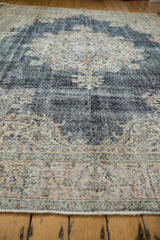 Close-up of distressed vintage Sparta carpet pile, showing worn knot heads and muted border.