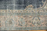 Distressed vintage Sparta carpet: faded navy blue field, ivory knot heads, dusty rose border.