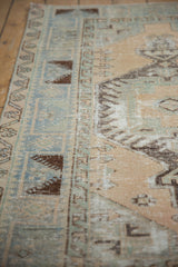 Distressed Oushak rug featuring unusual faded blue, mint green, and beige geometric border.