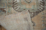 Hand-knotted reverse of the vintage Oushak rug, with worn beige and green pile.