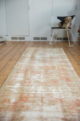 Long vintage Oushak runner, decorative distressed pile in pale terracotta and neutral tones.