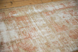 Distressed vintage Oushak rug texture with areas of visible foundation, showcasing pale terracotta and sand.