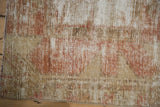 Close-up of worn vintage Oushak rug runner pile in pale terracotta and beige.
