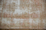 Distressed vintage Oushak rug texture, with exposed foundation in pale terracotta and beige.
