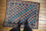 Antique Caucasian rug's sapphire blue field with vibrant ruby red geometric guls.