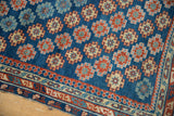 Antique Caucasian rug: diagonally arranged geometric guls in sapphire blue, ruby red, ivory, and edge wear.