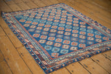 Antique Caucasian rug's vibrant sapphire blue field with ruby red geometric gul motifs.