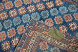 Folded corner of an antique Caucasian rug showing geometric patterns and original selvage.