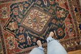 Antique Afshar carpet with central diamond medallion, serrated leaves, and geometric motifs in teal and red.
