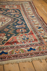 Antique Afshar carpet: terracotta and dark teal geometric patterns, visible knot heads, intact selvage.