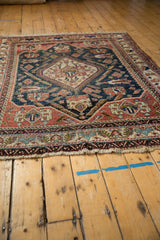 Detail of antique Afshar carpet's fringe and terracotta, navy, ivory geometric border.