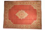 Dust brick red Vintage Oushak rug with antique ivory scalloped medallion and patterned border.