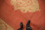 Vintage Oushak rug section with dust brick red field and ivory pattern, showing nuanced pile texture.