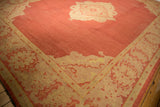 Oushak rug border showing saffron yellow serrated leaf and dust brick red palmette design.
