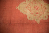 Scalloped medallion edge, antique ivory pattern on dust brick red Oushak field with abrashes.