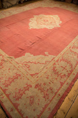 Vintage Oushak carpet corner detail, showing wide border with dust brick red serrated leaf and palmette motifs.
