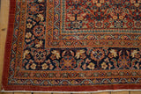 Vintage Mahal corner with henna plant pattern, dusty red borders, and noticeable pile wear.