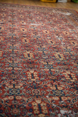 Vintage Mahal carpet detail: henna plant design in dusty red, navy, showing knot head wear.