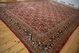 Persian Mahal rug corner: navy blue floral border, henna plant motif field.