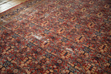 Vintage Mahal rug's dusty red and navy henna pattern with visible foundation wear.