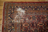 Worn corner detail of vintage Persian Mahal carpet showing exposed foundation and floral motifs.