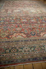 Antique Sultanabad rug's intricate floral, palmette, vinery field pattern in rust and blue.