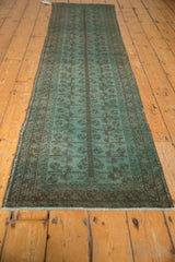 Dusty aqua blue vintage Belouch runner with pinwheel blossoms and central charcoal band.