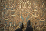 Distressed vintage Karaja carpet with geometric tendrils, soft blue, pink, and brown tones.