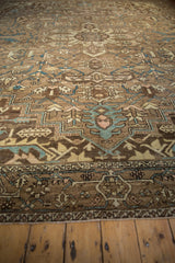 Distressed vintage Karaja carpet detail shows geometric vinery, dusty turquoise, coffee brown, and even wear.