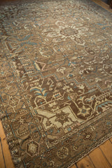 Distressed Karaja rug showcasing geometric tendrils in coffee brown, antique ivory, and dusty blue tones.