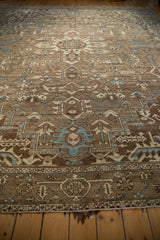Decorative distressed texture on a vintage Karaja rug, with geometric vinery in beige, brown, and dusty blue.