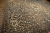 Distressed field of geometric tendrils, serrated leaves, and blue motifs with abrash.