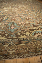 Geometric tendrils, serrated leaves, and abrash on distressed Karaja rug with brown and blue tones.