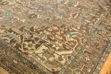 Distressed Karaja rug corner, geometric tendrils, serrated leaves in brown, beige, dusty blue.