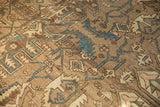 Distressed Karaja rug texture with geometric patterns in earthy browns and dusty blue.